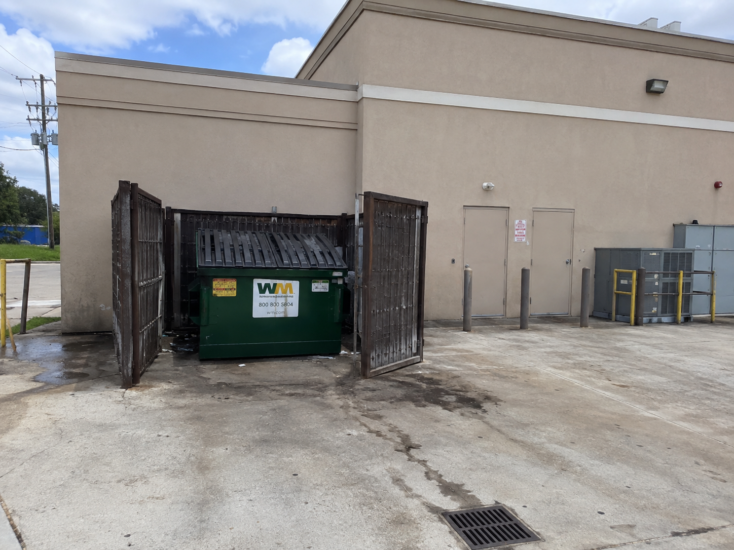 Before dumpster pad and service-area cleaning on a commercial property